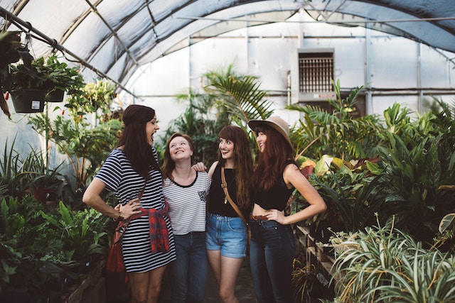 four women in a greenhouse, multiple speakers