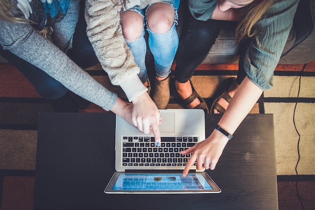 People sitting around computer