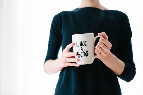 woman holding mug with like a boss