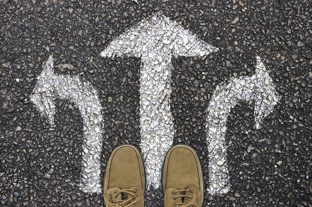 feet stood in front of three arrows pointing in different directions
