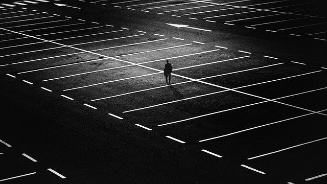 man alone in an empty parking lot