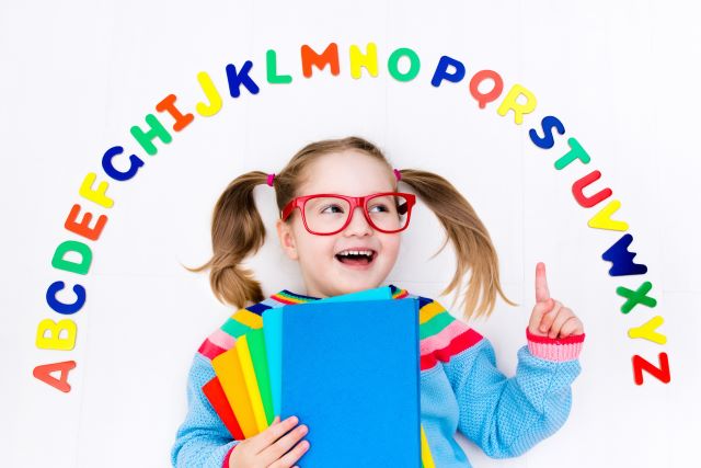 Girl Surrounded by alphabet letters