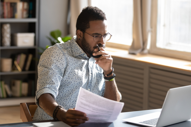 a man focussing intently on a laptop screen