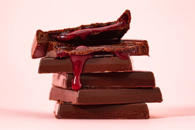  stack of chocolate squares oozing raspberry sauce 