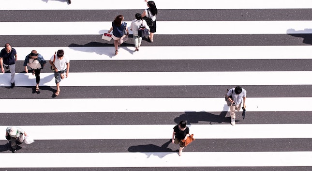 groups of people crossing parallel lines