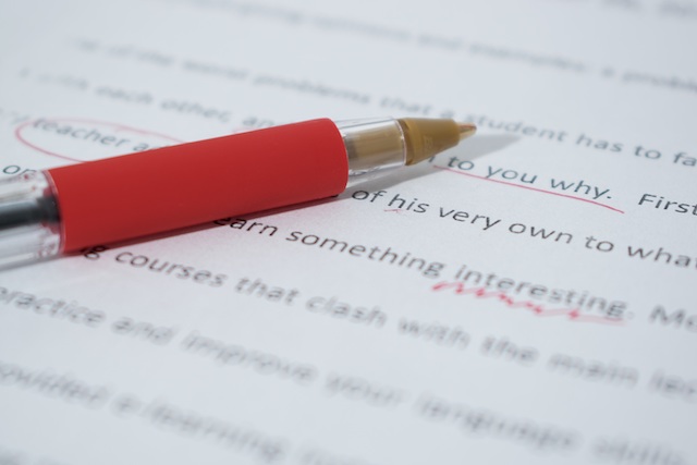 red pen and manuscript with edit marks