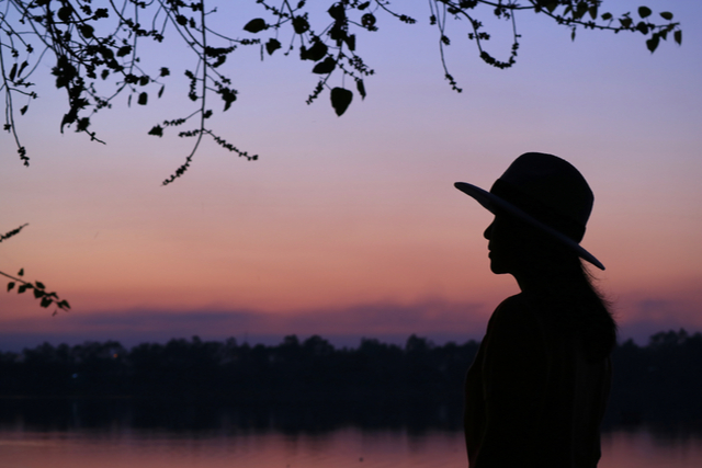 silhouette of a woman against a sunset