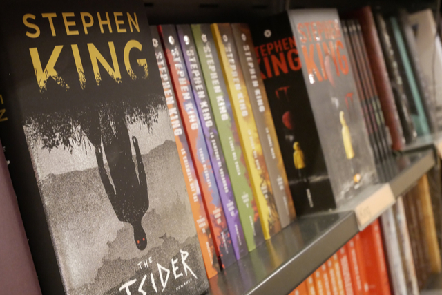 stephen king books on a shelf, spines out