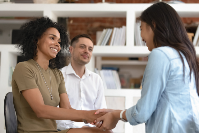 woman shaking hands warmly with a colleague