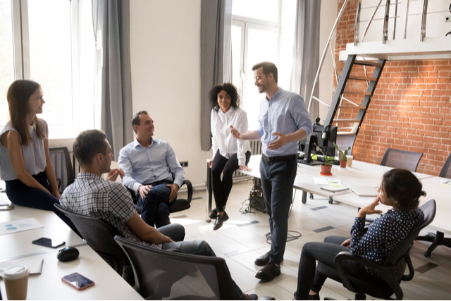 group of professionals listening to a presentation