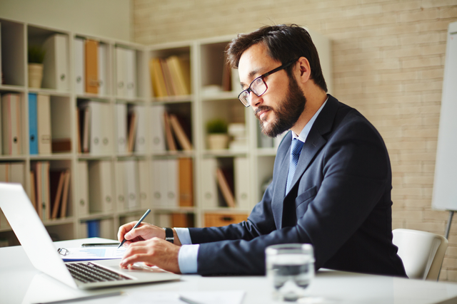 Business person Writing on Laptop