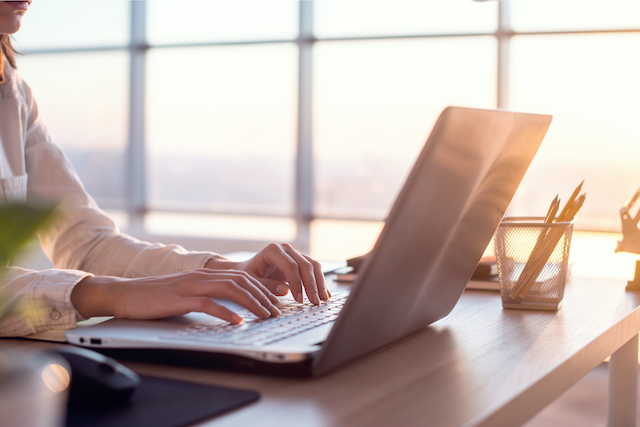 woman typing on laptop