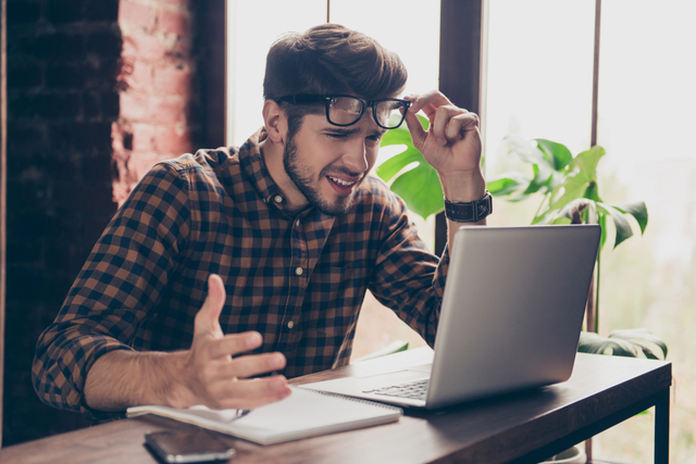 man looks angrily at his computer