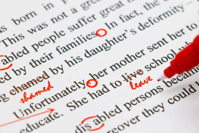 typed writing marked up with a red pen