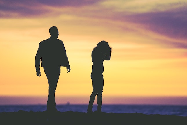 man and woman in an argument at sunset