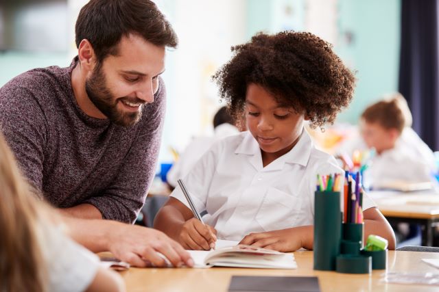 Teacher helps student writing