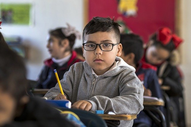 boy writing in class